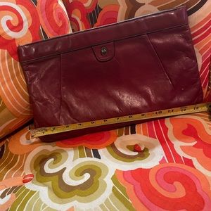 Vintage Etienne Aigner clutch. Burgundy leather with black piping.
